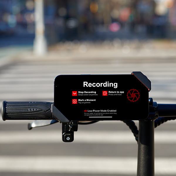 A smartphone secured in the dashcam.bike mount on bicycle handlebars